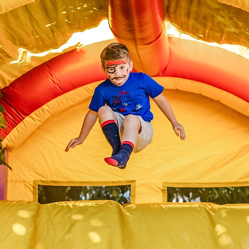 Kid enjoying inflatable castle at the Harness Life Event