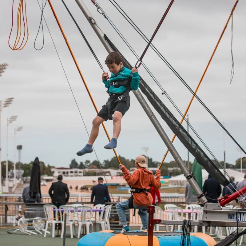 Kids enjoying trampoline ride at the Harness Life event