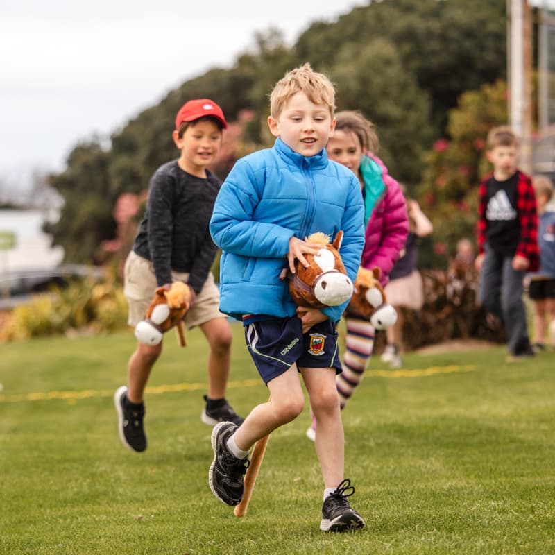 Kids enjoying and participating in races at the Harness Life event